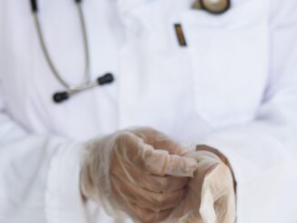 person in white lab coat and stethascop putting on surgical gloves. illustationg surgical operation of circumcision
