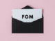 black envelope on a pink background with the letters fgm in the center